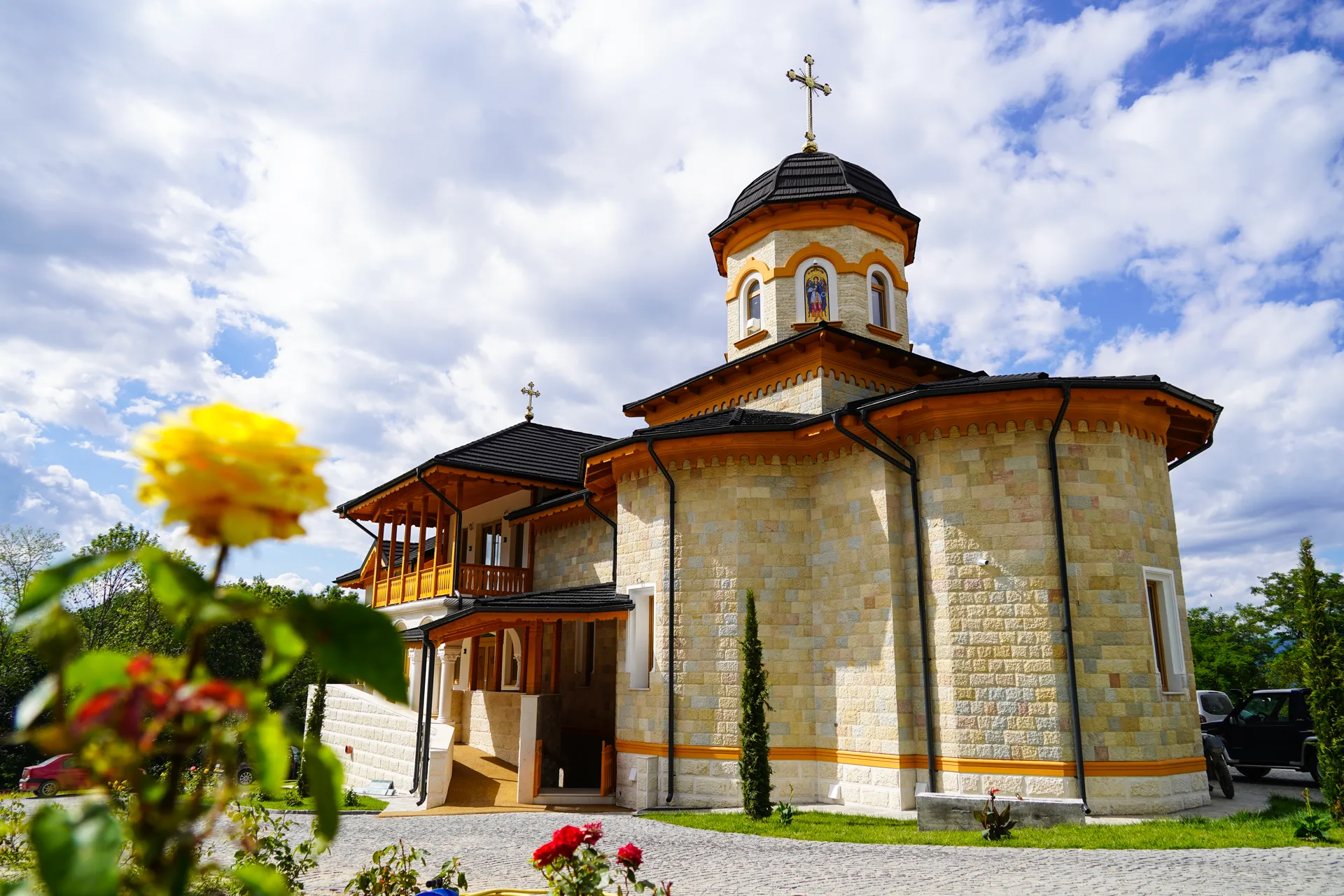 Biserica cu trandafiri galbeni în prim plan